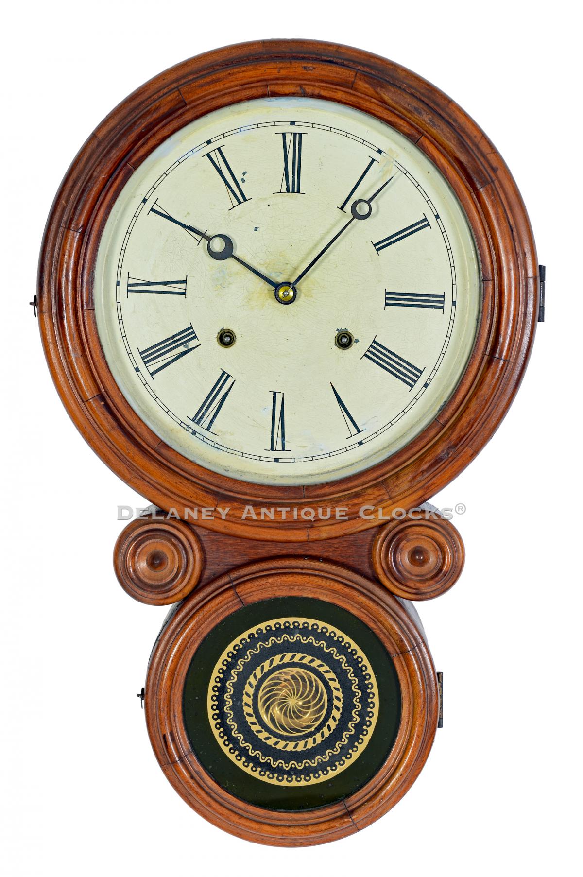 E. Ingraham & CO. Bristol, Connecticut. An Ionic wall clock in walnut.  223315A. | Delaney Antique Clocks